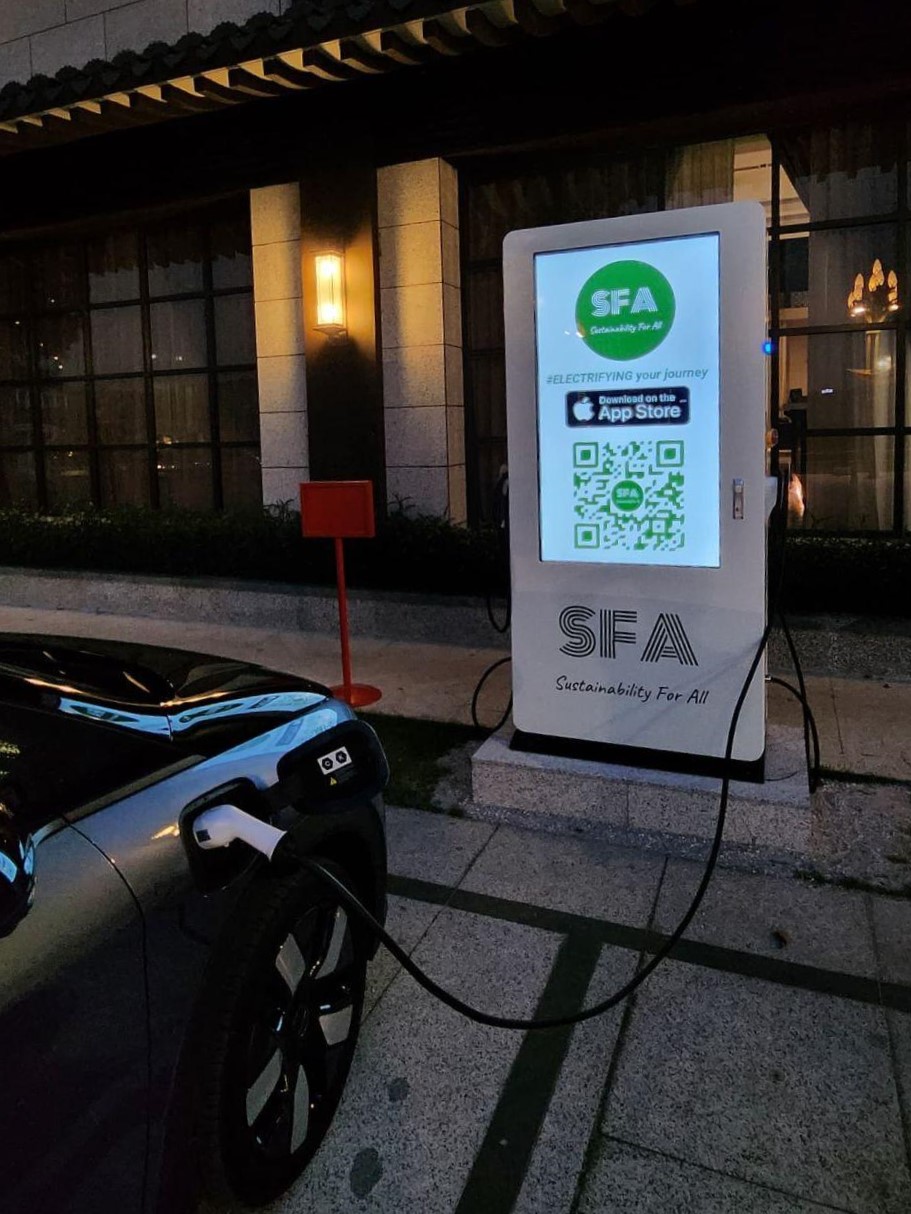 electric vehicle (EV) being charged at a public electric vehicle charging station