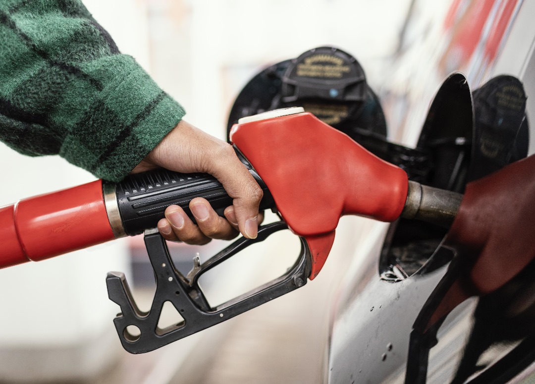 a person refueling a vehicle at a Shell petrol station